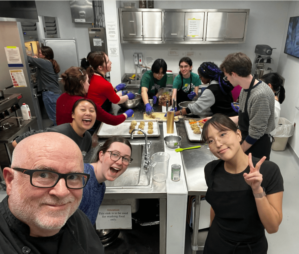 Students cooking in lab kitchen
